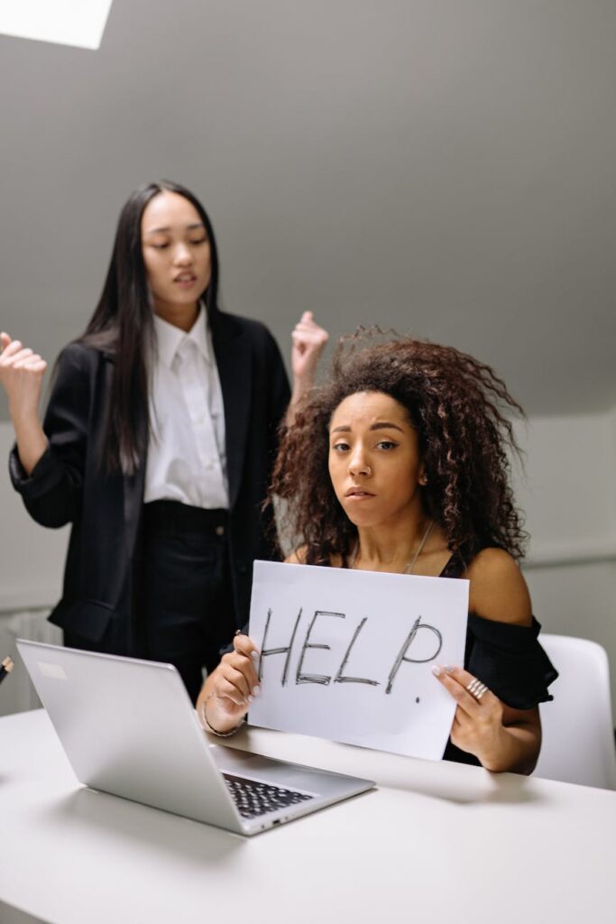 woman holding a paper in front of a laptop